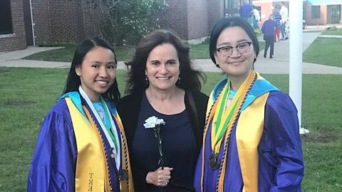 two students and guest posing at ceremony